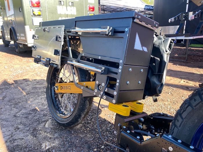 A closeup picture of the ADV1's right side with rails for attaching GiantLoop, Jesse, and Mosko Moto panniers. You can also see a folding gear shelf that is in the up position.