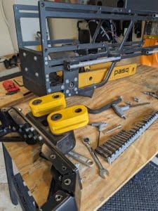The arms of the the Pasq ADV1 trapezoid hinge, seen while disassembled.