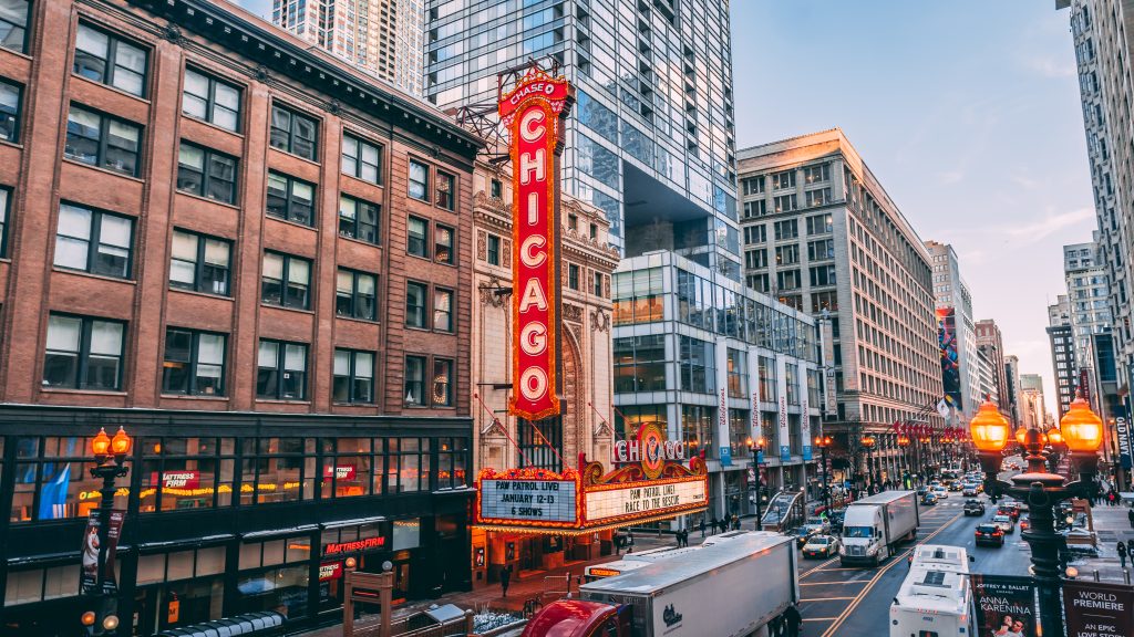A busy Chicago street with the Chicago Theater sign in the middle